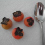 Persimmons with spoon to show size